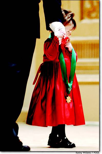 Two-year-old Patricia Smith holds her father's gloved hand Dec. 4 after accepting the New York Police Department's highest honor, the Medal of Honor, on behalf of her late mother, Officer Moira Smith, who died in the World Trade Center attacks. Patricia's father is also a police officer.