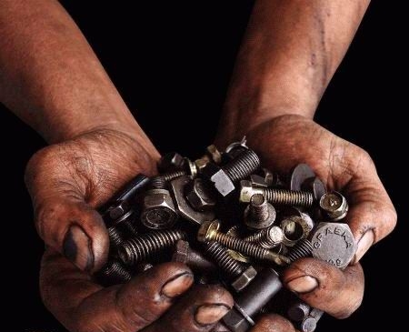 Image of hands holding bolts.