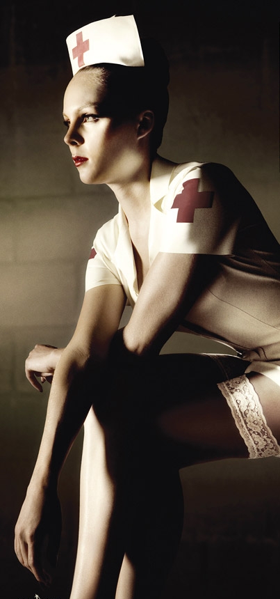 Picture of Red Cross nurse in an old-fashioned uniform, in color, but with sepia tone coloring.