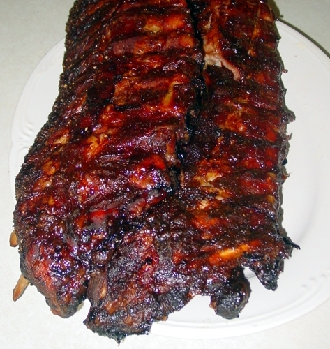 Cooked BabyBack Ribs, prepared with a rub and cooked with sauce on.